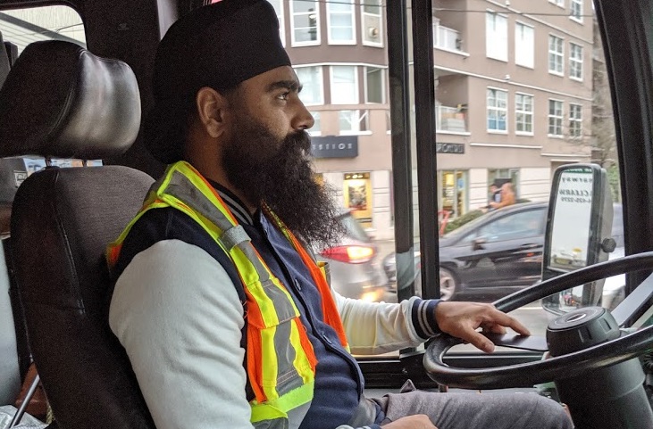 A Metro Vancouver bus driver works out of uniform as a part of ongoing job action. 