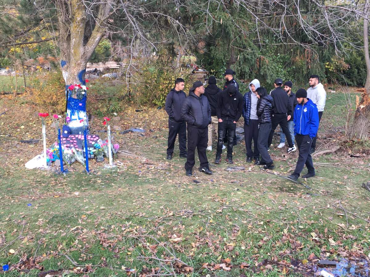 Friends attend a roadside memorial for Jaipartap Sidhu.