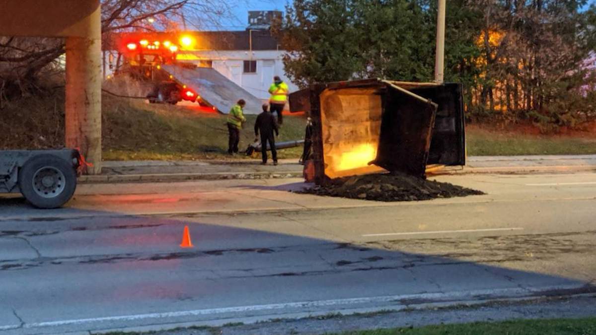 A container holding cement was spilled on a Trenton roadway after the truck carrying it struck a railway overpass.