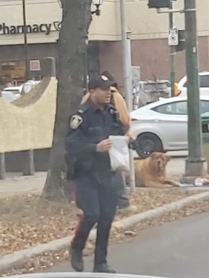 A Winnipeg police officer seen helping a homeless man's dog in a now-viral Facebook post.