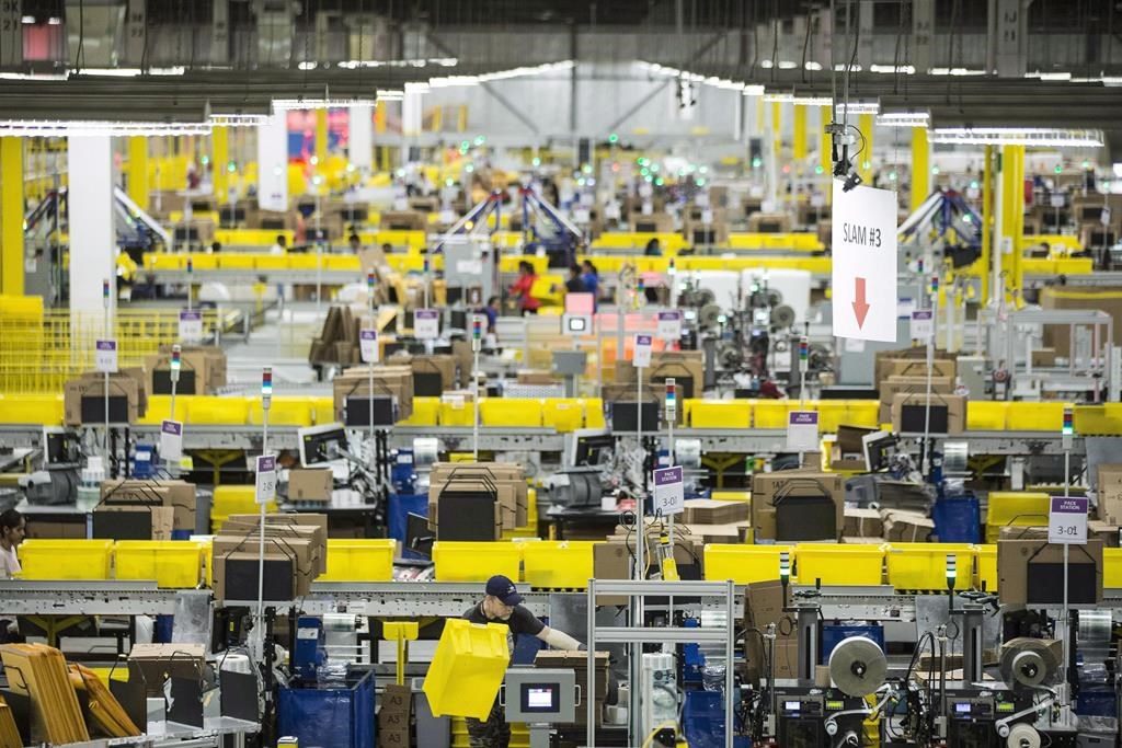Employees work at the Amazon fulfillment centre in Brampton, Ont. on November 26, 2018. Amazon says it plans to open open five facilities in Quebec. Tuesday, Jan. 19, 2021.