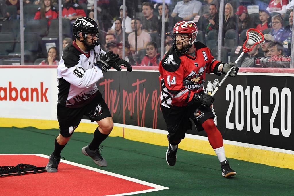 File: Calgary Roughnecks' Dane Dobbie, right, carries the ball against the Colorado Mammoth in Calgary May 10, 2019.