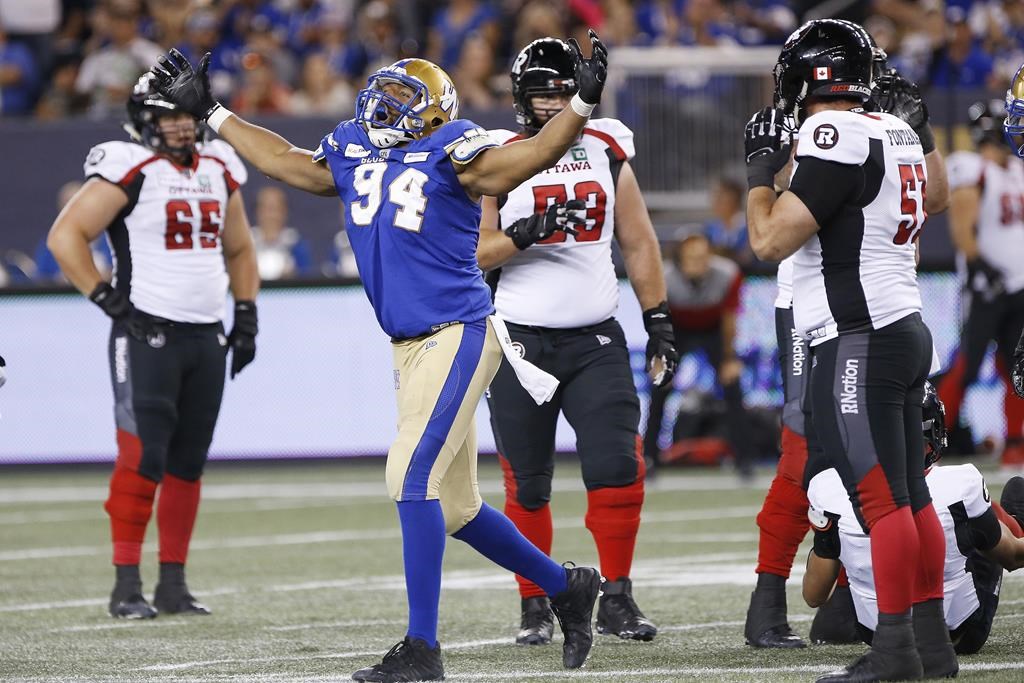 Winnipeg Blue Bombers' Jackson Jeffcoat (94) celebrates sacking Ottawa Redblacks quarterback William Arndt (8) during the second half of CFL action in Winnipeg, Friday, July 19, 2019. Jeffcoat, the six-foot-three, 253-pound defensive end had two of the six sacks a relentless Winnipeg defence registered Sunday in the Blue Bombers' stunning 33-12 Grey Cup victory at McMahon Stadium.