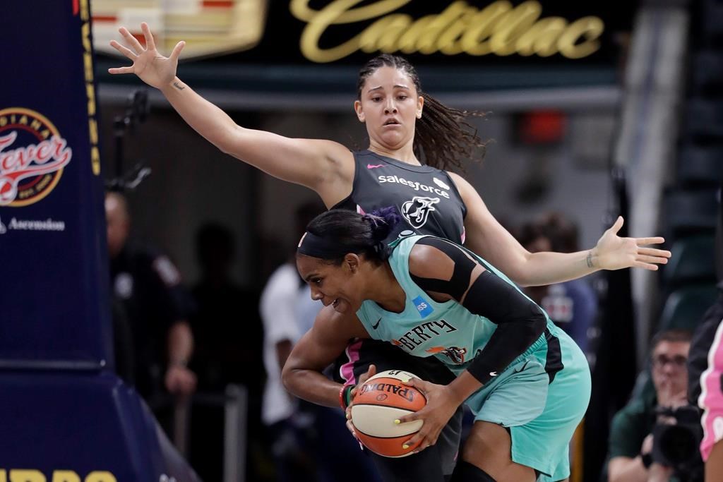 New York Liberty's Tina Charles (31) goes to the basket against Indiana Fever's Natalie Achonwa (11) during the first half of a WNBA basketball game in Indianapolis on August 20, 2019. It's been a whirlwind few weeks for Natalie Achonwa. She earned the WNBA's prestigious community assist award, and then on the weekend in South Bend, her jersey was raised up into Notre Dame's Ring of Honor. The forward is now in Edmonton to suit up Canada's women's basketball team for its next round of Olympic qualifying. THE CANADIAN PRESS/AP, Darron Cummings.