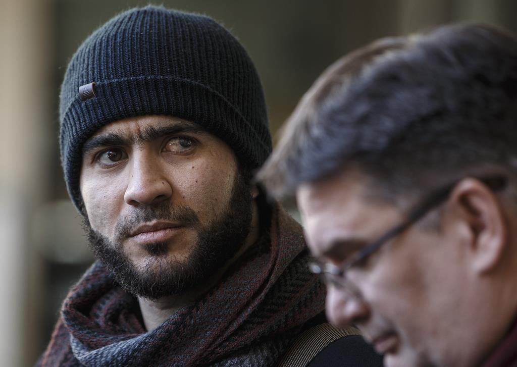 Former Guantanamo Bay prisoner Omar Khadr and his lawyer Nate Whitling speak with media outside the courthouse in Edmonton on February 26, 2019.