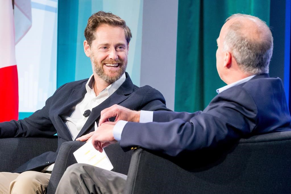 Ryan Holmes (left), CEO of Hootsuite, chats with Geoff Entress of Pioneer Square Labs at the 2017 Cascadia Innovation Corridor Conference in Seattle, Wash., Wednesday, Sept.13, 2017. Hootsuite Inc. CEO Ryan Holmes says he plans to step down as head of the company.