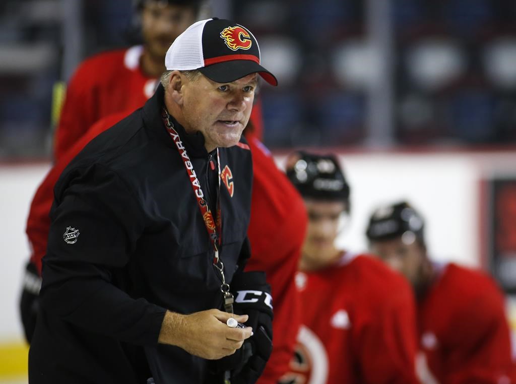 Fromer Calgary Flames head coach Bill Peters gives instruction during training camp in Calgary, Friday, Sept. 13, 2019. THE CANADIAN PRESS/Jeff McIntosh.