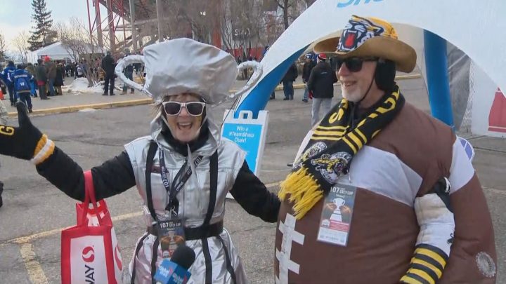 Shiny in silver, Sheree Bashak dressed as the Grey Cup, and her husband Steve Bashak was costumed as a football in Calgary on Sunday, Nov. 24, 2019.