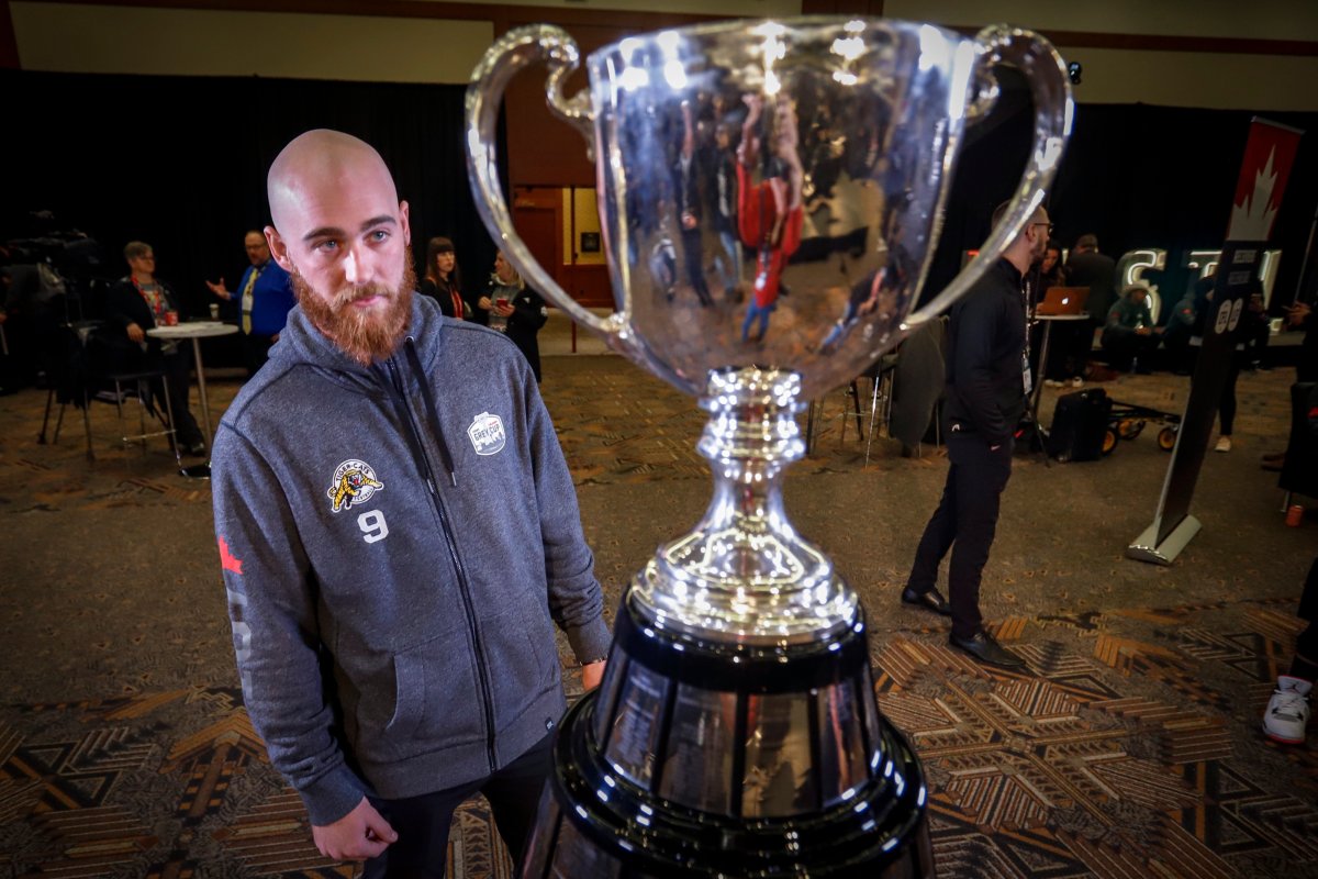 Hamilton Tiger-Cats quarterback Dane Evans looks at the Grey Cup trophy during media day at the CFL Grey Cup in Calgary, Thursday, Nov. 21, 2019.