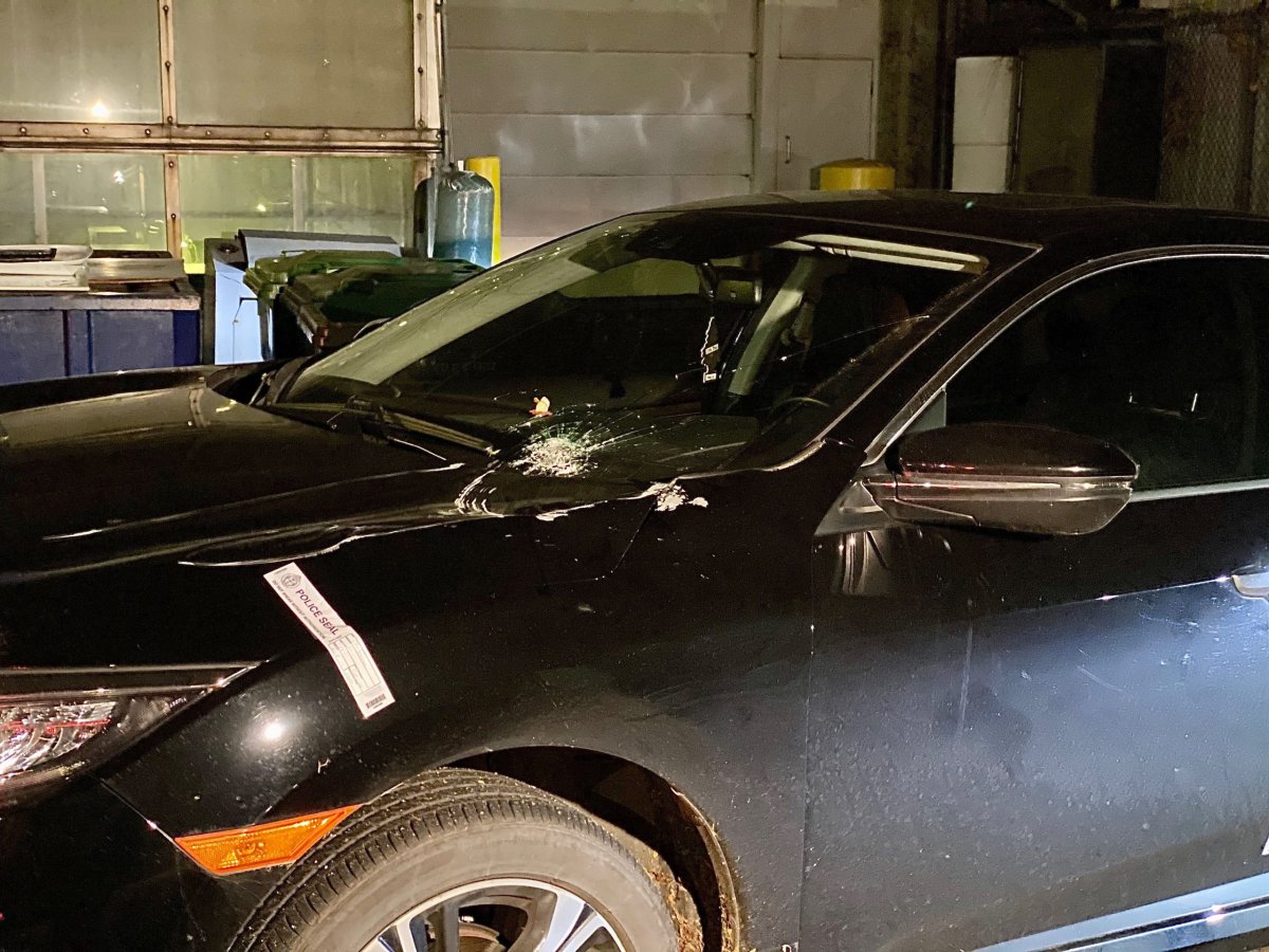 Police examine a damaged vehicle near Don Mills Road early Friday.