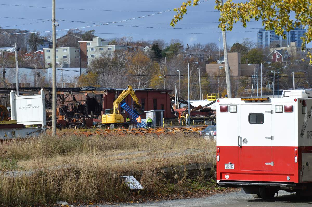 Halifax Regional Fire and Emergency investigators sweep through the scene of a fire at a CN rail yard at Chisholm Avenue on Nov. 10, 2019.