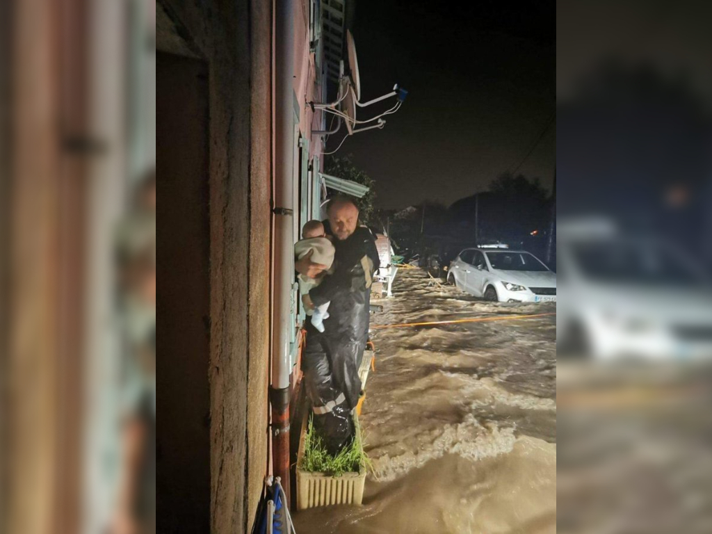 Firefighter Gilbert Baldicchi rescues Gabriel, a four-month-old baby, from a home in Pegomas, France on Nov. 23, 2019.