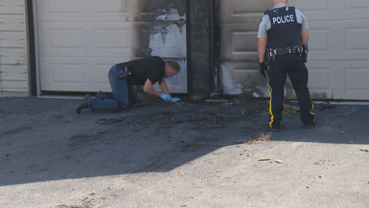 Fire investigators collect evidence at house fire Aug. 30 in Kelowna. 