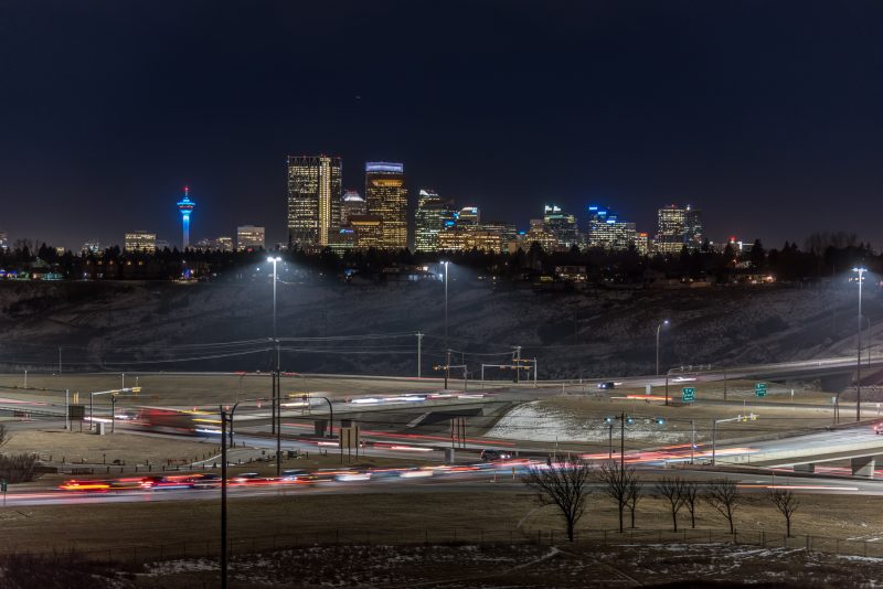 Calgary skyline at night with Deerfoot Trail in the foreground.