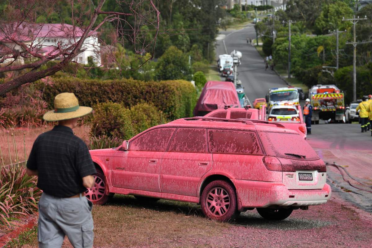 A car sprayed with fire retardant is seen after a bushfire in a residential area of Sydney on Nov. 12, 2019. (Photo by Saeed KHAN / AFP) (Photo by SAEED KHAN/AFP via Getty Images)