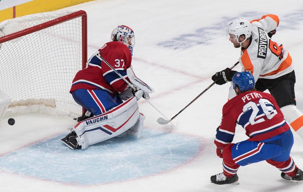 Philadelphia Flyers' Ivan Provorov (9) scores against Montreal Canadiens goaltender Keith Kinkaid as Canadiens' Jeff Petry defends during overtime NHL hockey action in Montreal, Saturday, Nov. 30, 2019.
