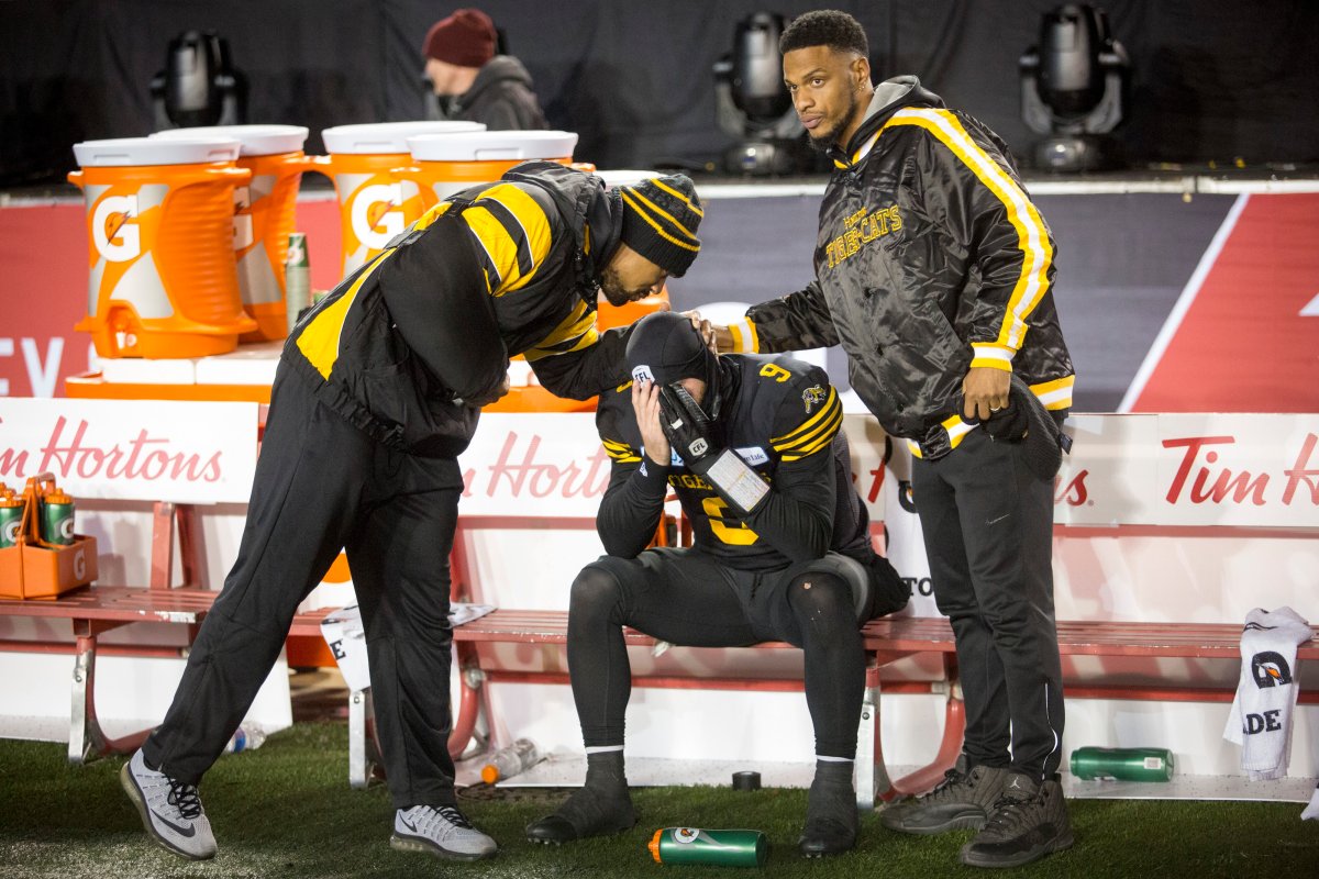 Hamilton Tiger-Cats quarterback Dane Evans, centre, is comforted following the team's loss to the Winnipeg Blue Bombers in the CFL Grey Cup in Calgary, Sunday, Nov. 24, 2019.