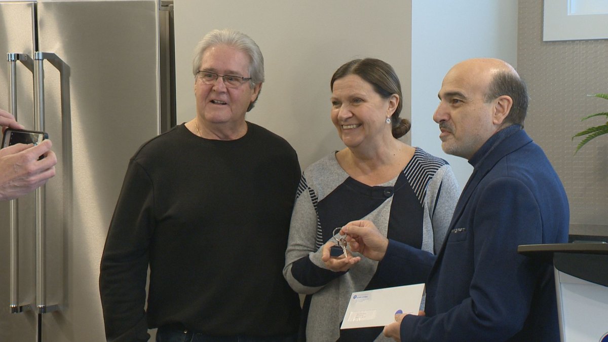 Peter and Tina Naylen of Regina won the Hospitals of Regina Foundation Home Lottery grand prize show home, valued at $1.1 million. They're presented the new keys to their home by HRF President and CEO Dino Sophocleous.