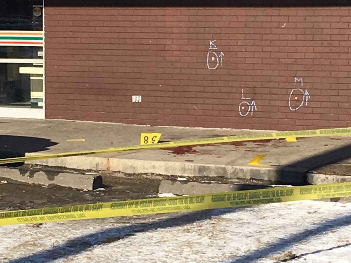 Police continued to investigate at the scene of the shooting Friday.