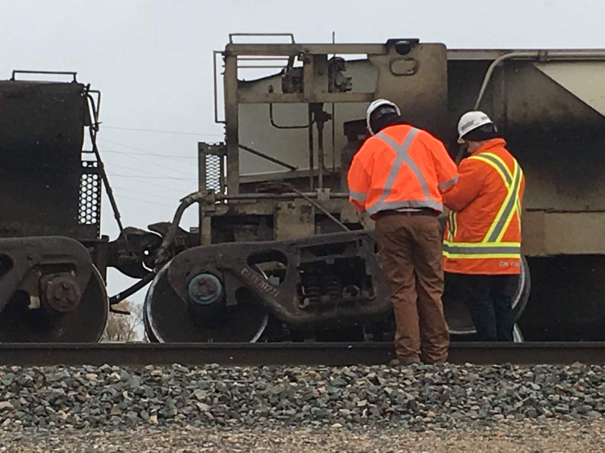 Workers gather near the train derailment Friday afternoon.
