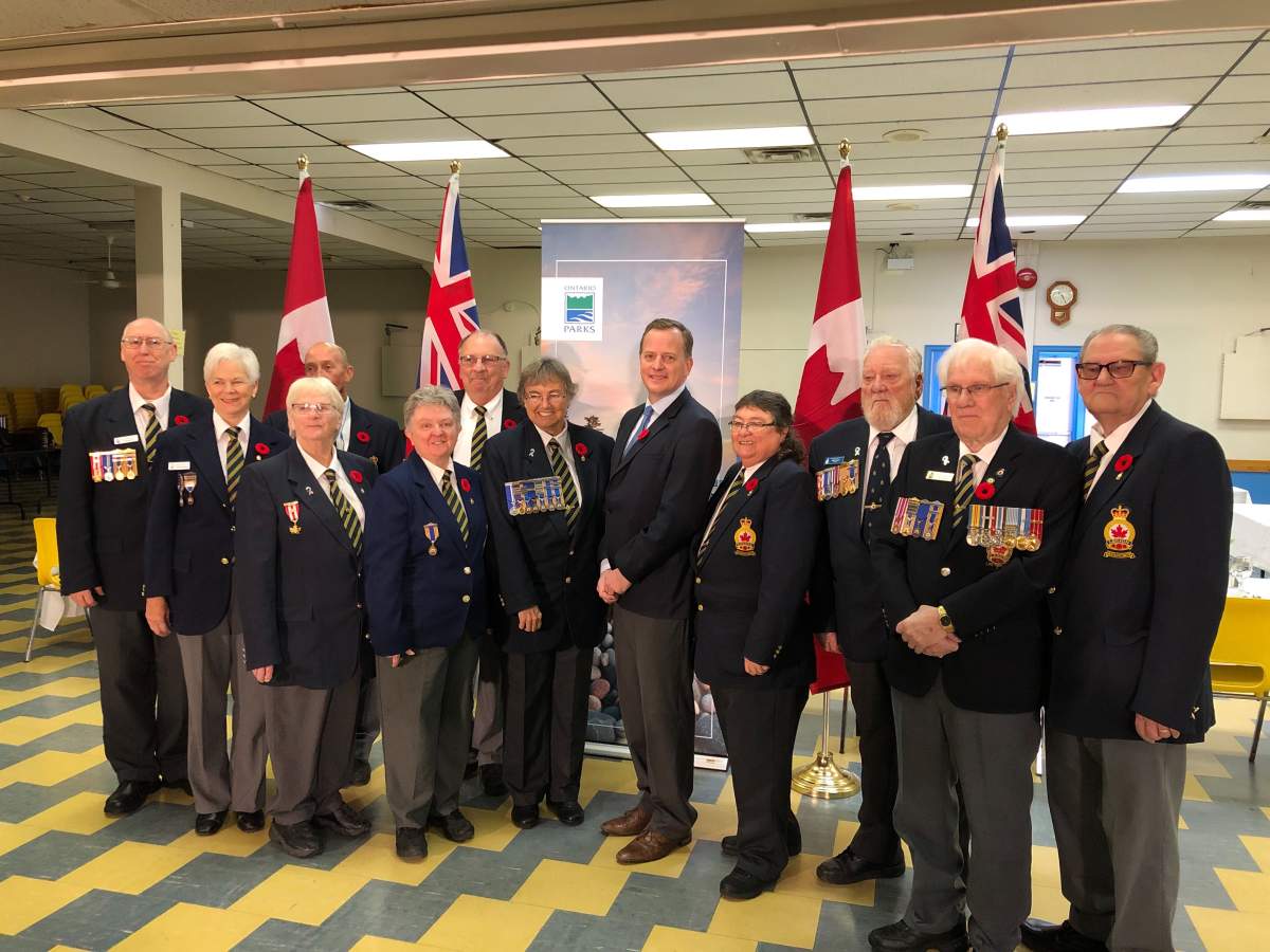 Environment Minister Jeff Yurek (middle) poses with a group of veterans and members from the Royal Canadian Legion in St. Thomas following Friday's announcement.