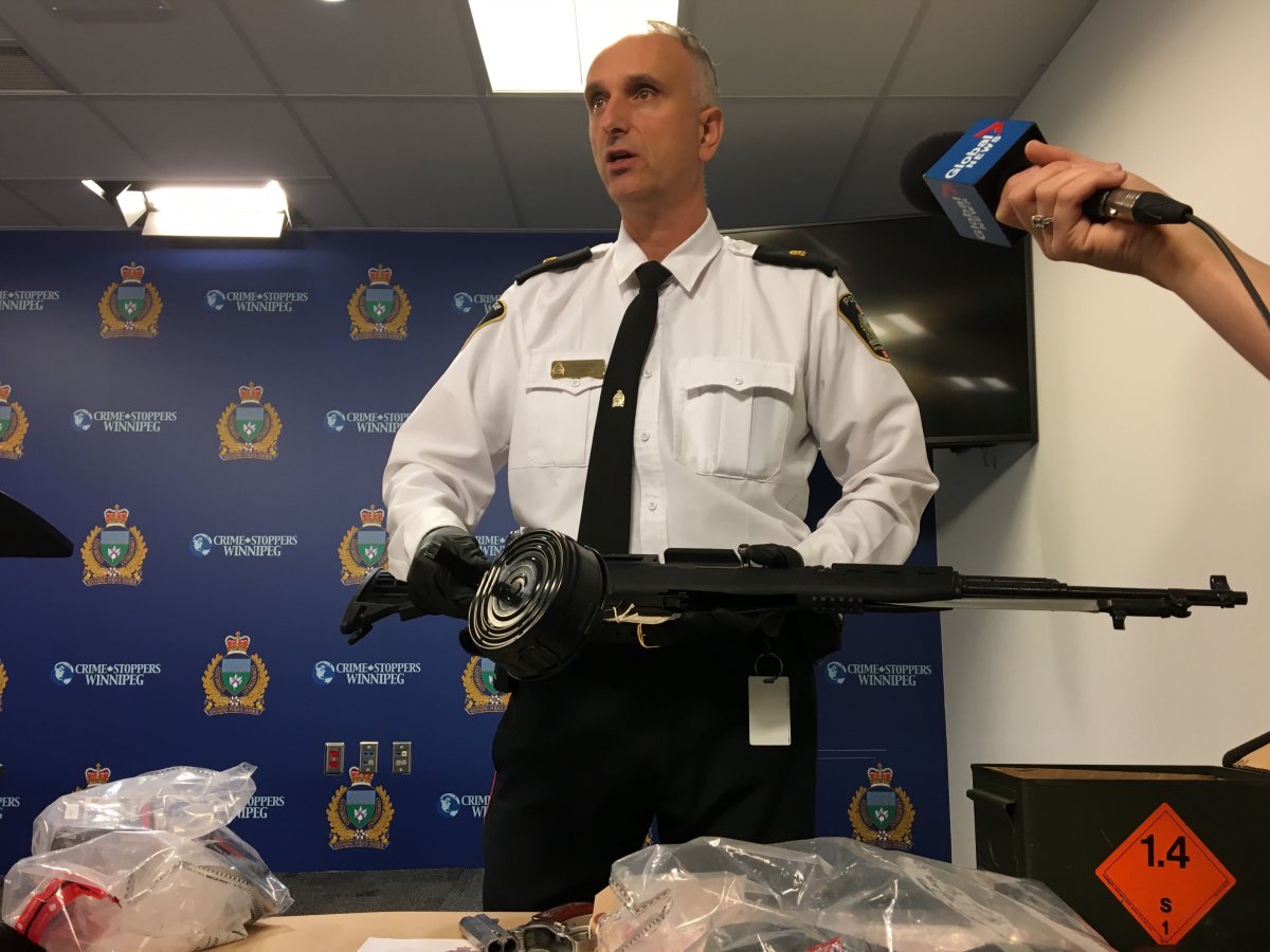 Insp. Max Waddell holds one of the guns seized.