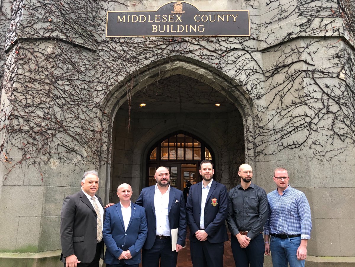 From left to right: York Developments chairman Mike Meddaoui, Middlesex County CAO Bill Rayburn, York Developments president Ali Soufan, Middlesex County warden Kurtis Smith, Nathan Campbell of EllisDon and Randy Reymer of EllisDon stand in front of the Middlesex County building on 399 Ridout St. 