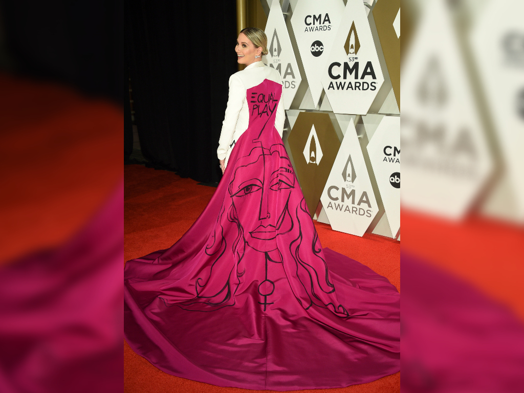 The back of Nettles’ cape read “Equal Pay” alongside a drawing of a woman with the female gender symbol.