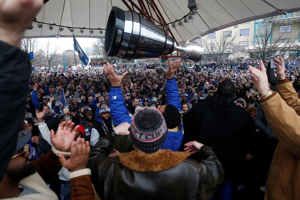 Winnipeggers are crowding the downtown streets Tuesday, Nov. 26, 2019, to celebrate as Andrew Harris raises the cup to the end of a Grey Cup drought that lasted almost three decades. The city is hosting a parade this afternoon after the Winnipeg Blue Bombers won their 11th Grey Cup with a 33-12 victory over the Hamilton Tiger-Cats on Sunday in Calgary. THE CANADIAN PRESS/John Woods.