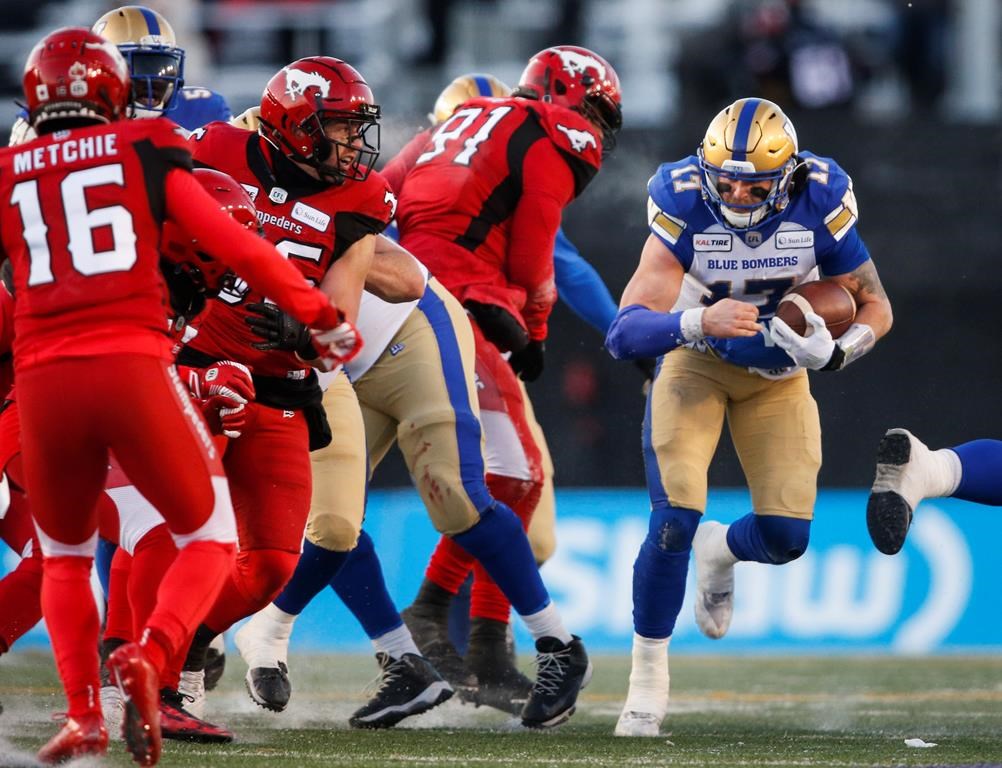 Winnipeg Blue Bombers quarterback Chris Streveler, right, runs the ball during CFL West Semifinal football action against the Calgary Stampeders, in Calgary, Sunday, Nov. 10, 2019.