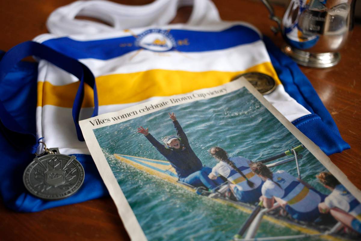 Former University of Victoria coxswain Lily Copeland shows off her national championship medals, uniform and celebratory newspaper clipping after winning the Brown Cup while being photographed at home in Brentwood Bay, B.C., on Saturday, November 16, 2019.