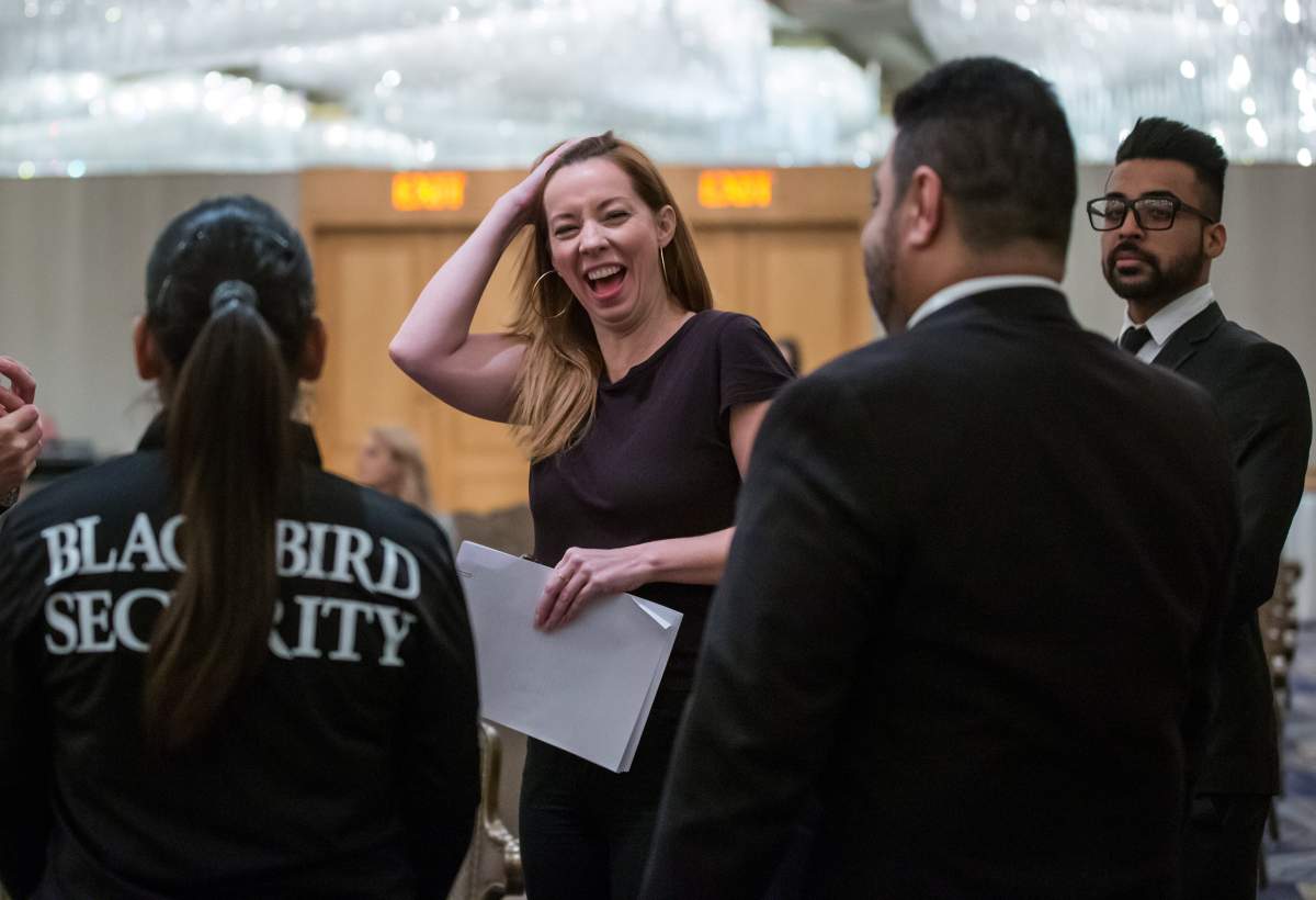 Writer Meghan Murphy laughs while flanked by security before speaking during a panel discussion on gender identity in Vancouver, Saturday, Nov. 2, 2019. 