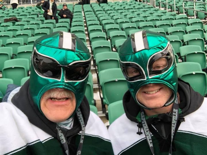 Nelson Hackewich (right) and his dad, Lance, cheer on the Roughriders during Saturday’s game at Mosaic Stadium.