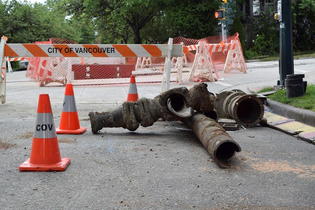 Unearthed pipes lie on Vancouver's East 12th Avenue, which is undergoing construction to replace a water main on July 14, 2019. According to the City of Vancouver, the existing water main is predicted to be over 100 years old, having been installed between 1906 and 1909. In Canada, where provinces _ not the federal government _ set water safety rules, the main source of lead in drinking water is antiquated pipes. (Mackenzie Lad/Institute for Investigative Journalism/Concordia University via AP).