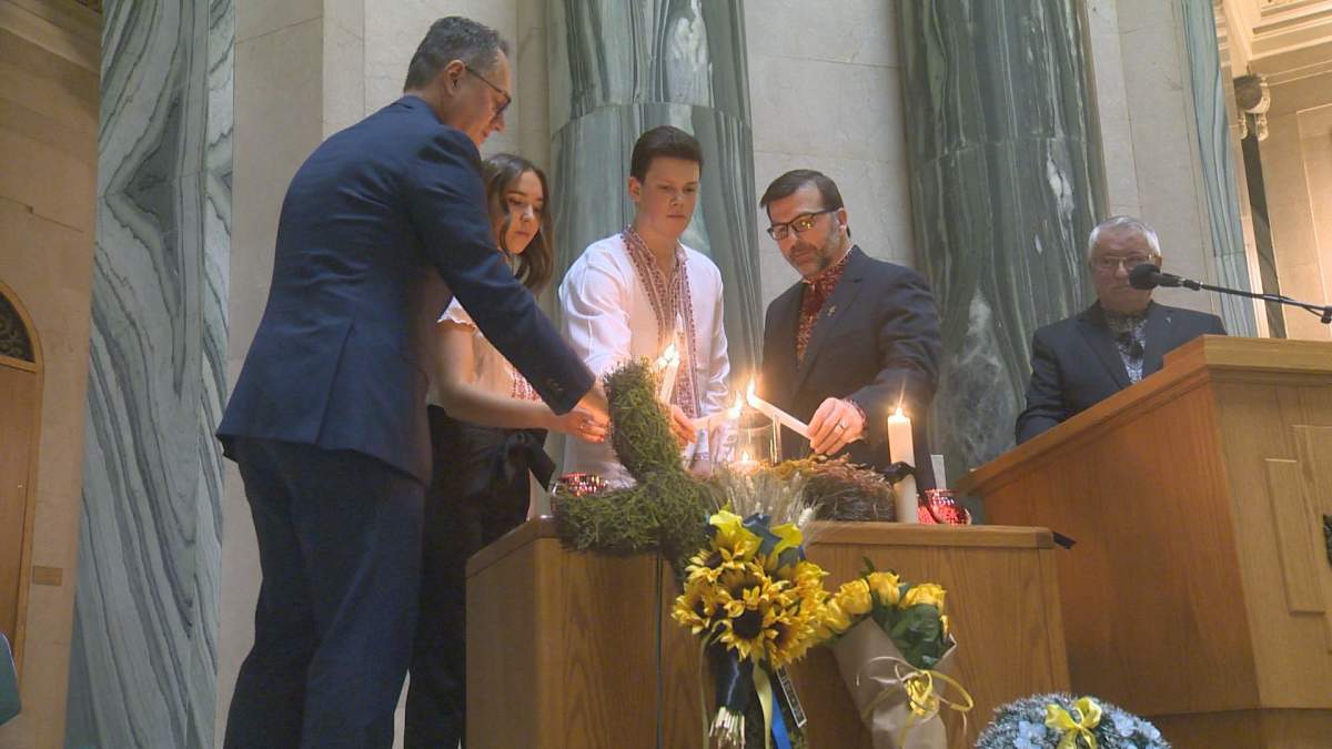 Greg Ottenbreit, the minister responsible for Saskatchewan-Ukrainian relations, lights a candle at the Saskatchewan legislature to commemorate Holodomor. 