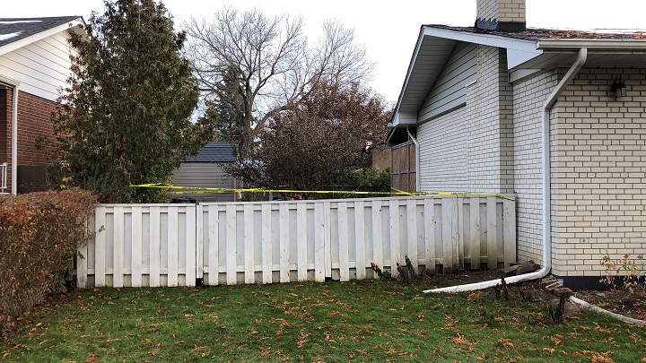 A photo of the backyard area taped off by police.