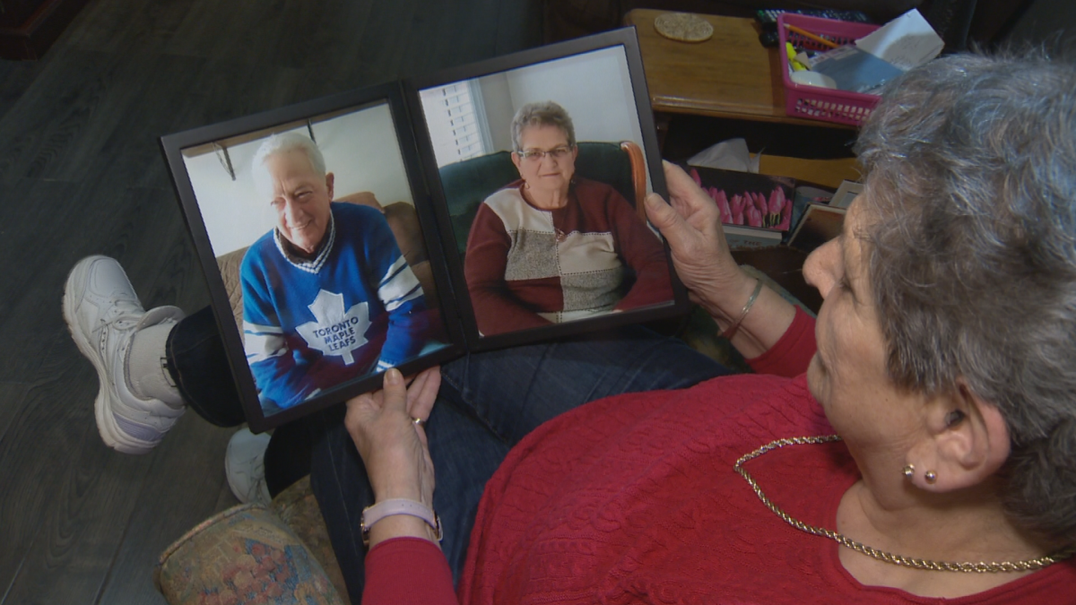 Shirley Stuart looks at a photo of her and her husband, Gary