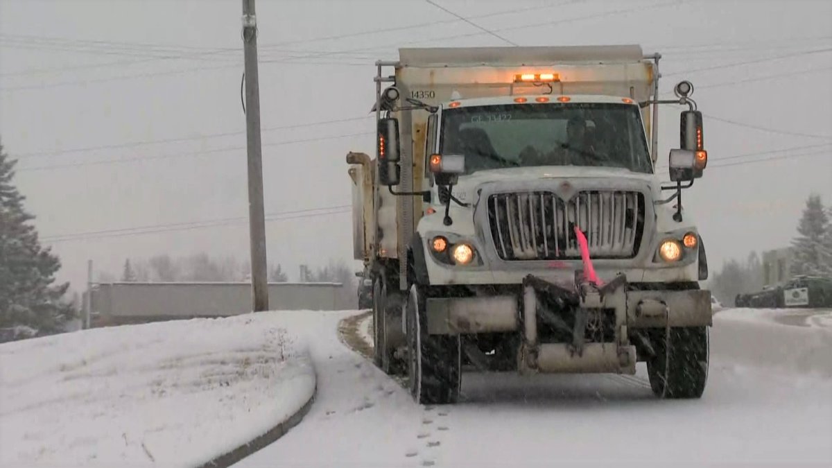 The City of Calgary works to salt and clear snow-covered streets. 