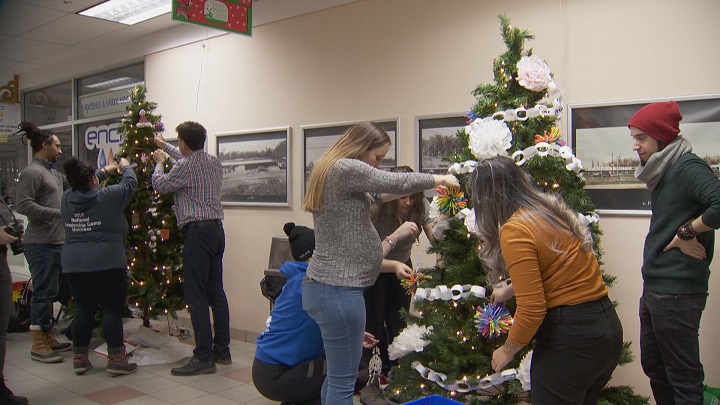 Community groups are hard at work at Plaza Pointe-Claire decorating Christmas trees for annual contest. Friday, Nov. 29, 2019.