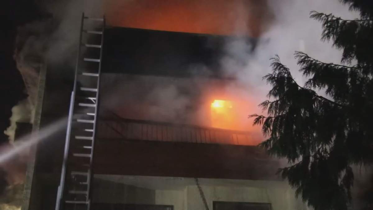 Flames shoot from an apartment building in Surrey overnight.  