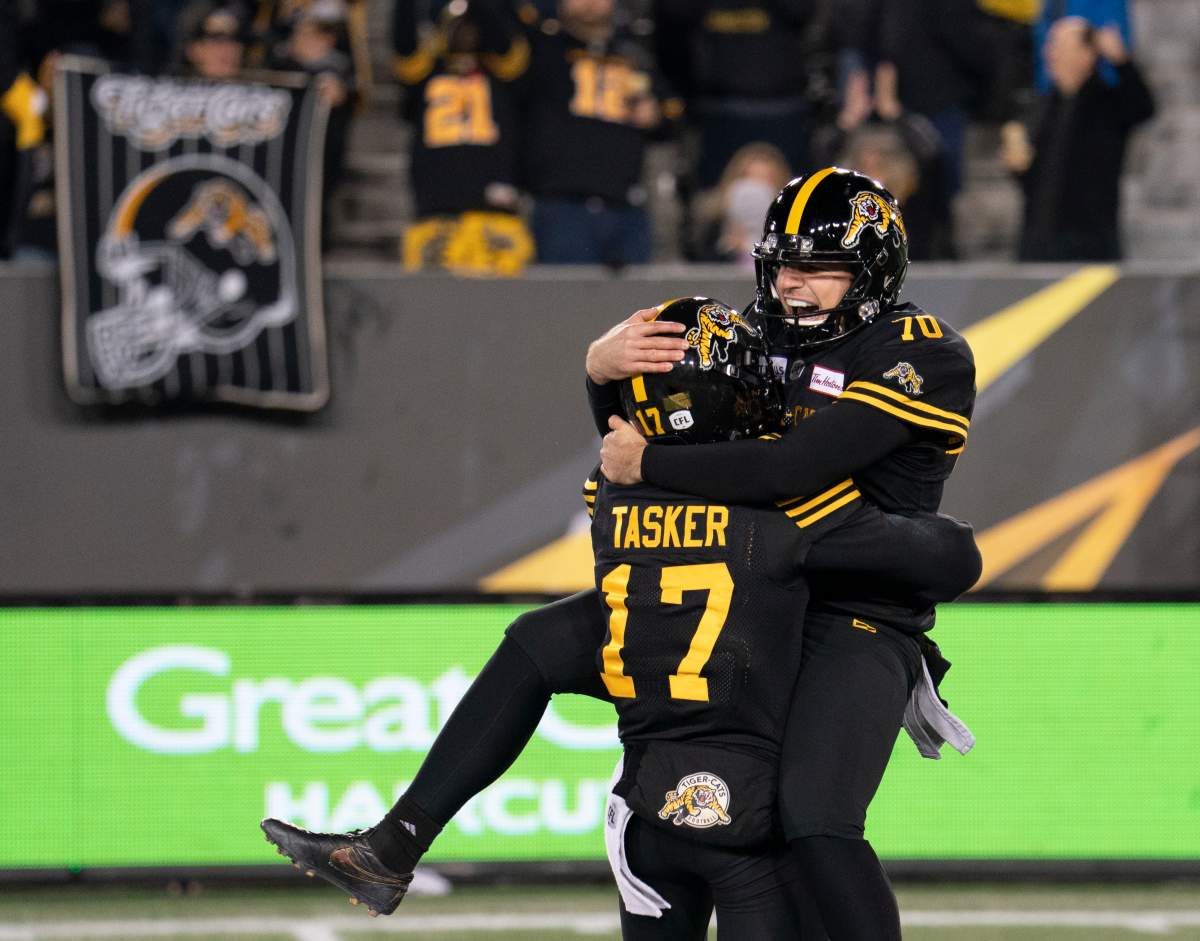 Hamilton Tiger Cats kicker Lirim Hajrullahu (70) celebrates his game-winning field goal with teammate Hamilton Luke Tasker(17) during secondhalf CFL football game action against the Hamilton Tiger Cats in Hamilton, Ont. on Saturday, Nov. 2, 2019.