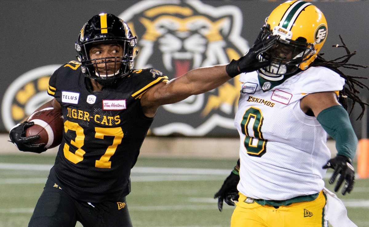 Hamilton Tiger Cats defensive back Frankie Williams (37) gets a hand into the face of Edmonton Eskimos linebacker Don Unamba (0) during second half CFL football game action in Hamilton, Ont., Friday, Oct. 4, 2019.