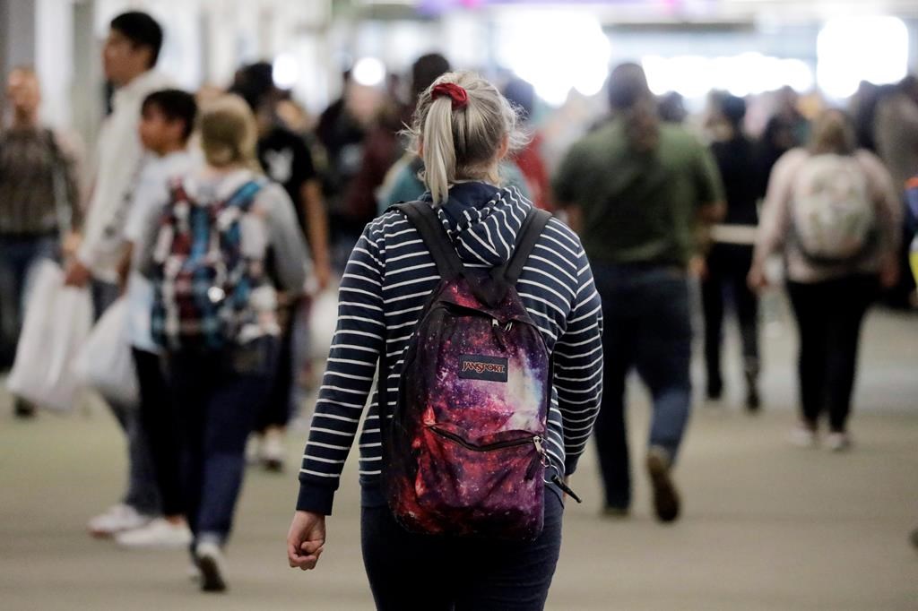 In this Nov. 14, 2019, photo, students walk on the campus of Utah Valley University, in Orem, Utah. (AP Photo/Rick Bowmer).