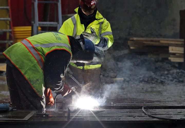 A 2015 file photo showing workers welding at a commercial construction site. 