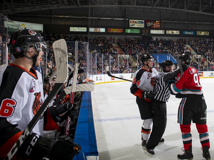 Cole Clayton of the Medicine Hat Tigers, left, and Mark Liwiski of the Kelowna Rockets exchange words during WHL action in Kelowna, B.C., on Friday night.