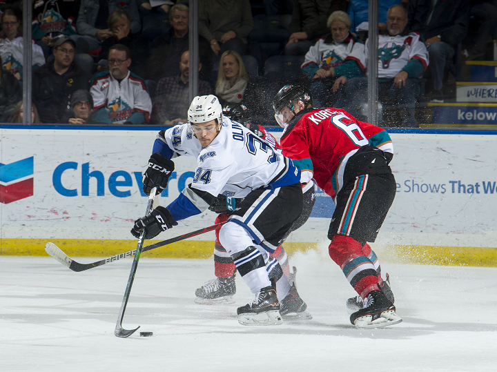 Kaid Oliver of the Victoria Royals, left, fends off a pair of Kelowna Rockets, including defenceman Kaedan Korczak, right, during WHL action in Kelowna on Wednesday night.