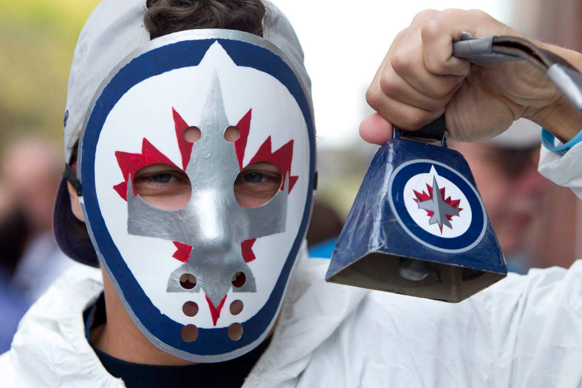 A Winnipeg Jets fan holds up a cowbell before the Jets inaugural game against the Montreal Canadiens at the MTS Centre in Winnipeg, Sunday, Oct. 9, 2011. THE CANADIAN PRESS/Jonathan Hayward