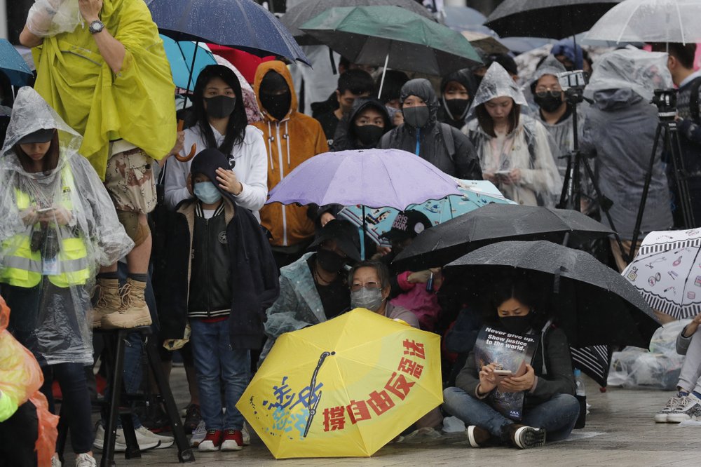 Protesters sit down near an umbrella with the words "Support freedom, Against Evil Law" during a rally in Hong Kong on Sunday, Dec. 29, 2019. Protests that began in June over a proposed extradition law have spread to include demands for more democracy and other grievances. 