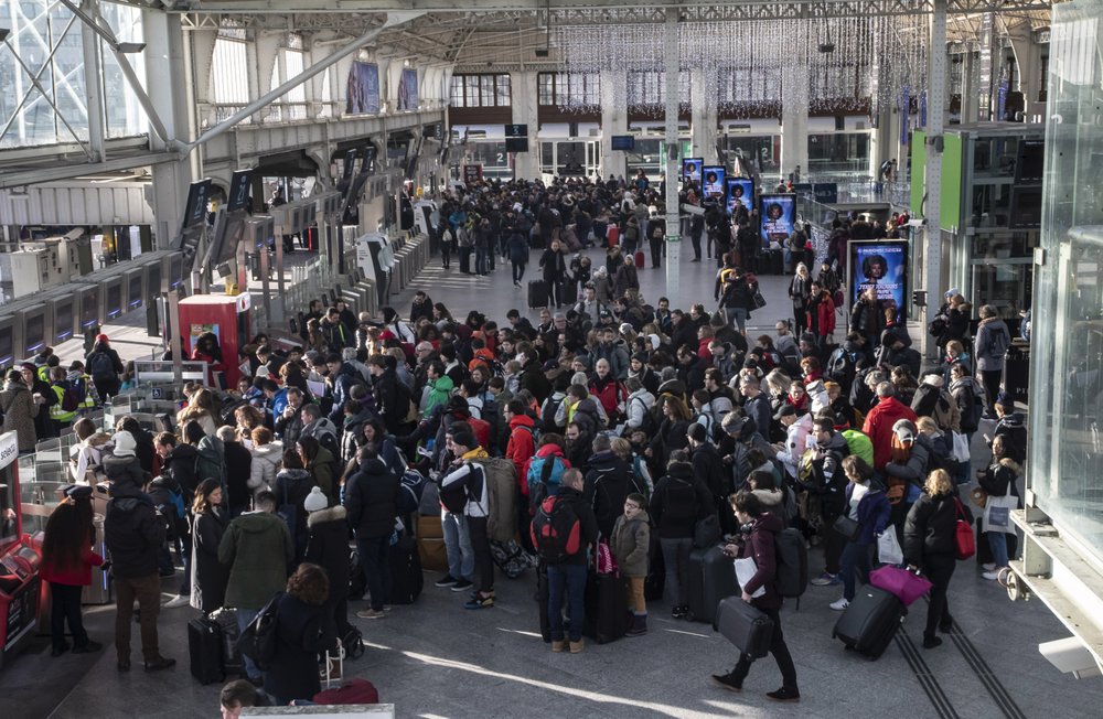 Travelers waiting to to board a train at Gare de Lyon train station in Paris, Sunday, Dec. 29, 2019. Strikes, which began Dec. 5, have disrupted transport across France and beyond, hobbling Paris Metros and trains across the country and businesses. 