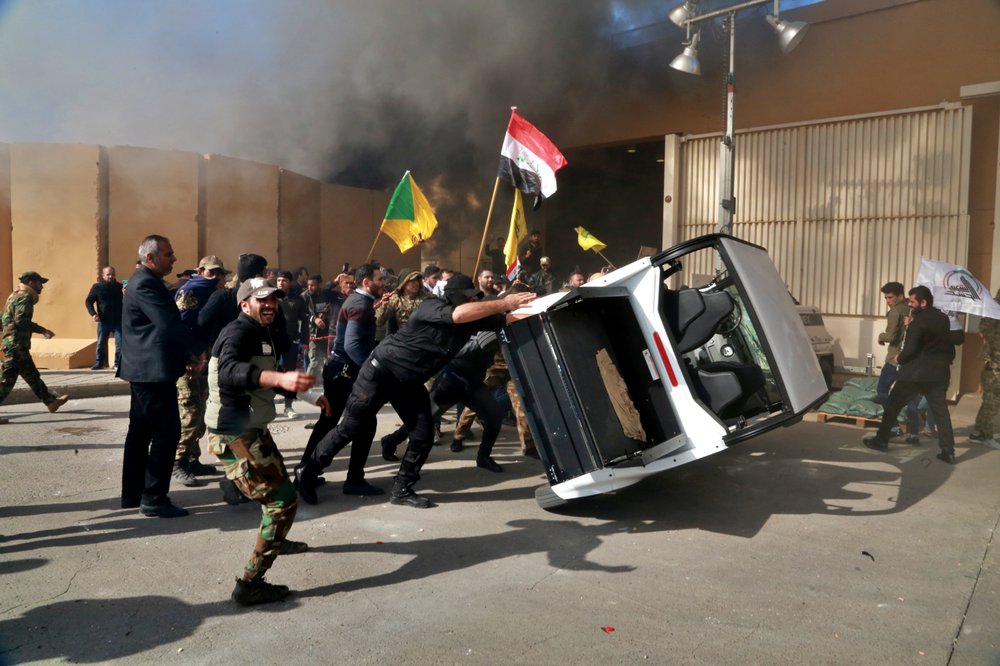 Protesters damage property inside the U.S. embassy compound, in Baghdad, Iraq, Tuesday, Dec 31, 2019. Dozens of angry Iraqi Shiite militia supporters broke into the U.S. Embassy compound in Baghdad on Tuesday after smashing a main door and setting fire to a reception area, prompting tear gas and sounds of gunfire.